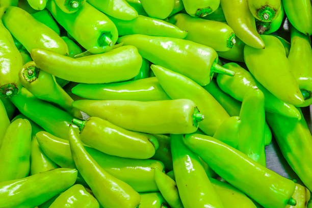 Many green chillis are overlapped, shot from supermarket