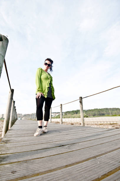 istock Smiling Woman Posing On A Wooden Pier/Bridge 1051777602