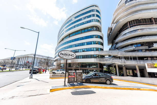 Watergate hotel on New Hampshire avenue sign building in capital city, residential building architecture, parking garage entrance with price Washington DC, USA - April 5, 2018: Watergate hotel on New Hampshire avenue sign building in capital city, residential building architecture, parking garage entrance with price hotel watergate stock pictures, royalty-free photos & images