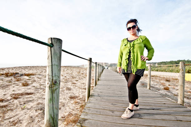 istock Smiling Woman Posing On A Wooden Pier/Bridge 1051780128