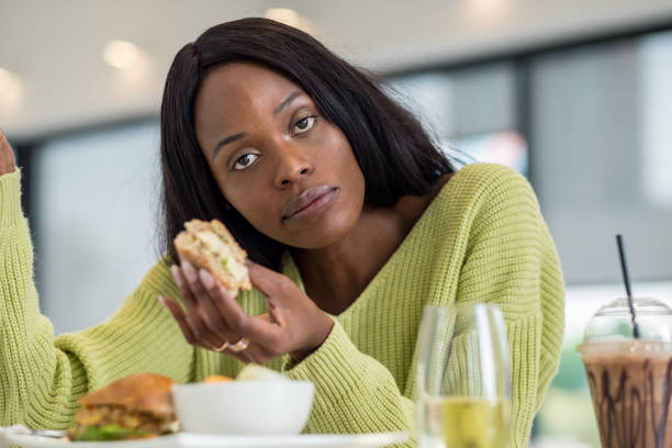 istock Young black woman at lunch 1051780492