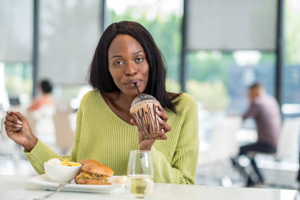 istock Young black woman at lunch 1051780570