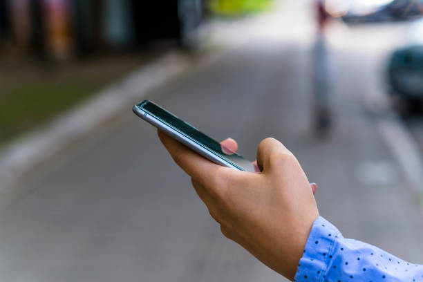 istock Woman Using a Smart Phone in the City Streets 1051780950