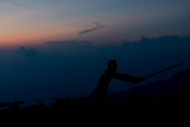 istock Shadow of Samurai with sword practice fencing and beautiful mountain view after Sunset 1051783968