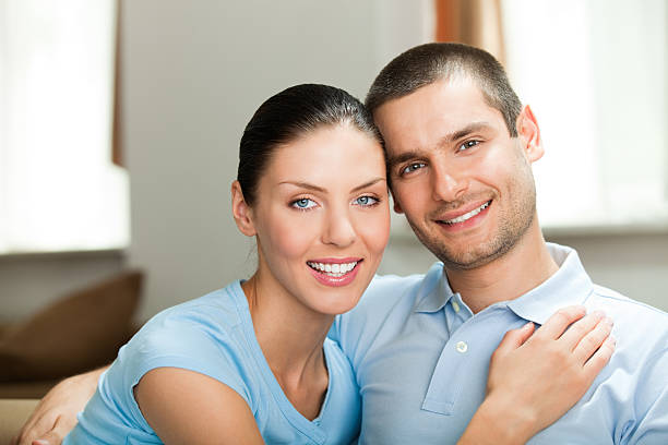 istock Young happy smiling attractive couple at home 105178728
