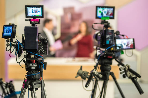 Two cameras filming a TV-show Rear view of two cameras filming an infomercial TV-show. television studio photos stock pictures, royalty-free photos & images