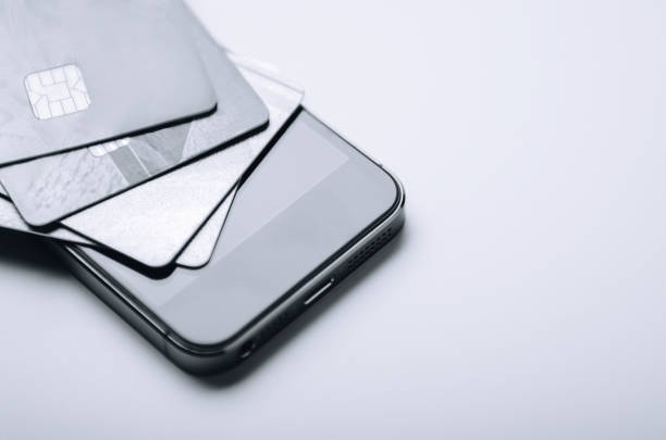 istock Credit cards on the phone. Online payment, shopping from home. Creative processing. copy space. 1051798388