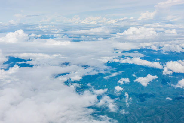 istock Aerial view of clouds and blue sky through airplane window 1051799776