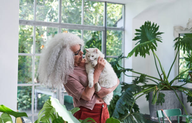 Senior woman cuddling a cat