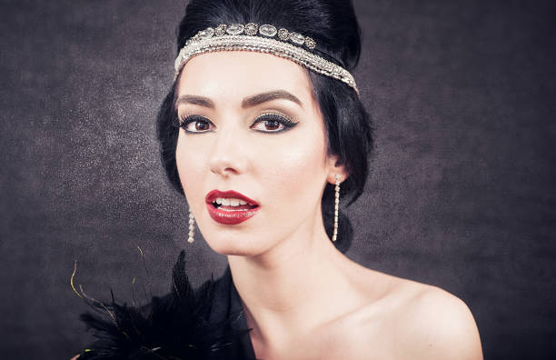 istock Sensual brunette  closeup with twenties retro look on black glowing background 1051805580