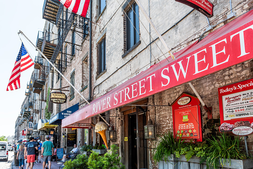 Savannah, USA - May 11, 2018: Old town River street in Georgia famous southern town, city, shopping stores shops, red decorations with sweets desserts