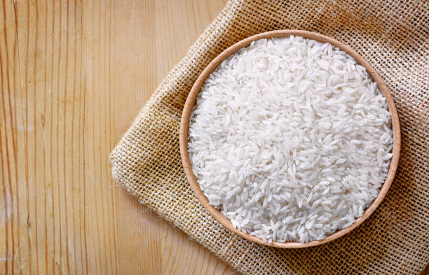 istock Raw, parboiled rice in a wooden bowl 1051814094