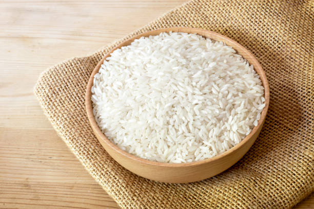 istock Raw, parboiled rice in a wooden bowl 1051814178