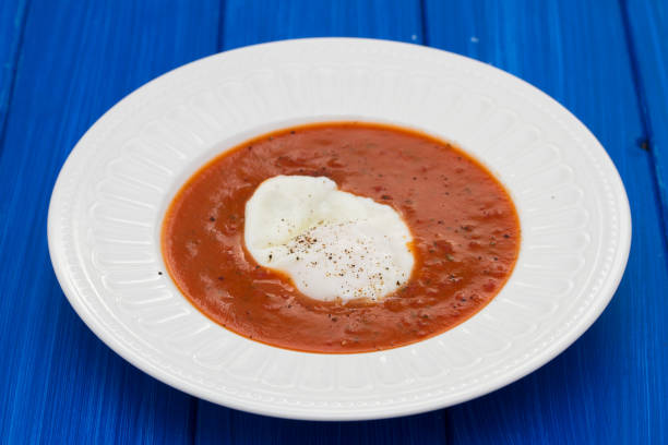 tomato soup with egg in white plate tomato soup with egg in white plate madeira sauce stock pictures, royalty-free photos & images