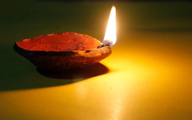 istock Diya oil lamps on a dark yellow background,copy space for text 1051819922