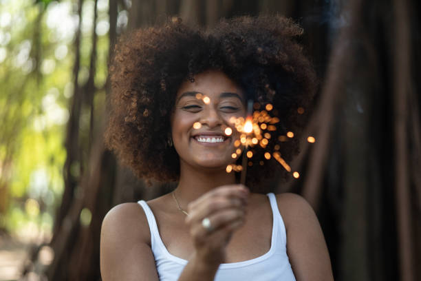 Curly Hair woman burning sparklers Wishing glittering burning stock pictures, royalty-free photos & images