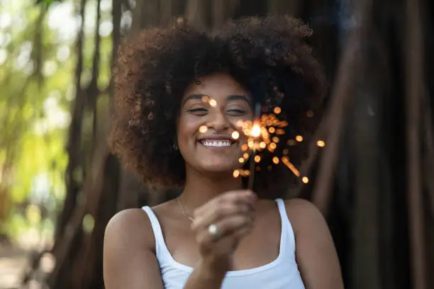 Photo of Curly Hair woman burning sparklers