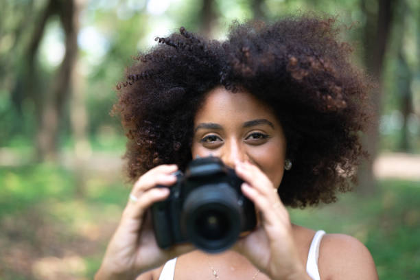 istock Curly Hair Girl Having fun while photographing 1051820030