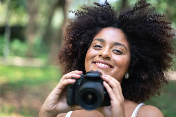 istock Curly Hair Girl Having fun while photographing 1051820344