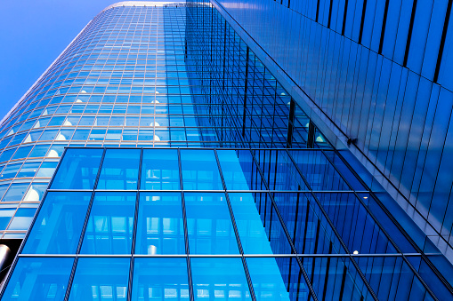 Modern glass blue business building facade in the city center of Warsaw, Poland