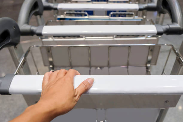 Young women pushing luggage trolley
