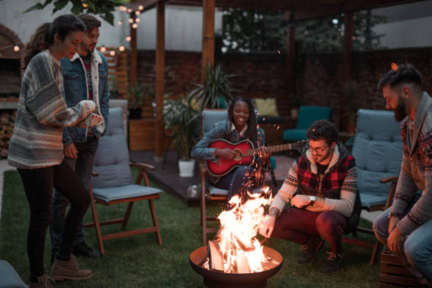 istock Group of Friends Gathered Around a Fire Pit 1051855960