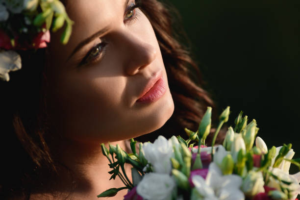istock Woman with flowers 1051857630