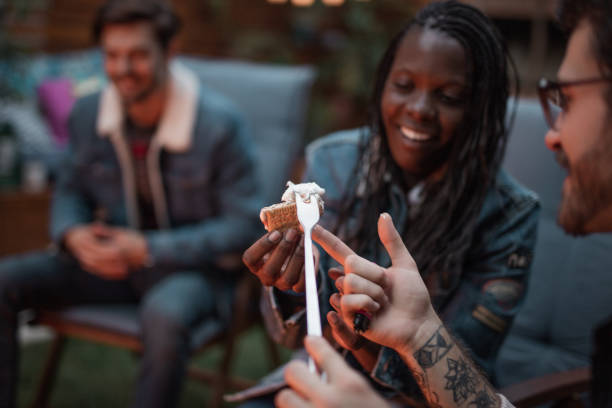 istock Millennial woman making s'mores 1051879804