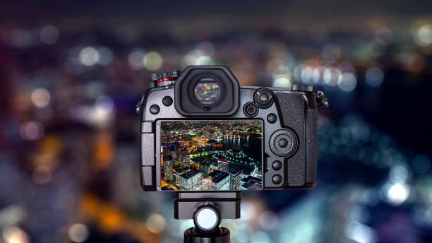 Digital camera over tripod on bokeh Night light Yokohama cityscape hight view with modern building in Japan