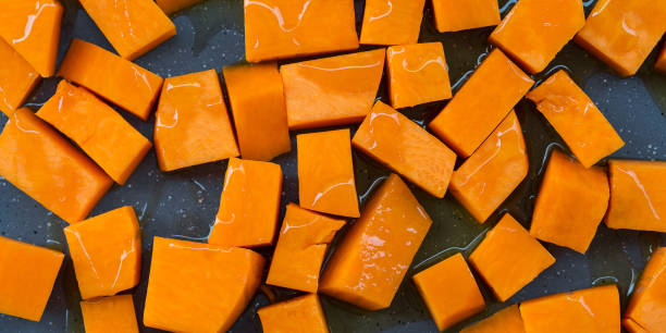 istock Chopped pumpkin drizzled with oil for baking 1051910104