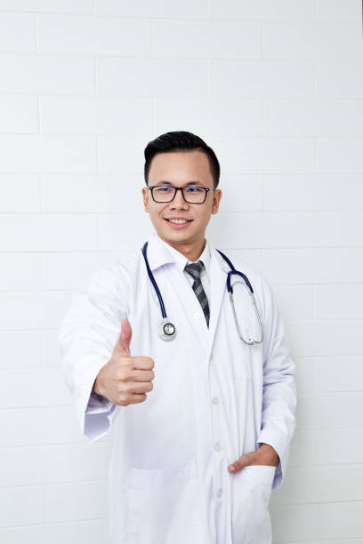 istock Handsome male doctor giving thumb up 1051937528