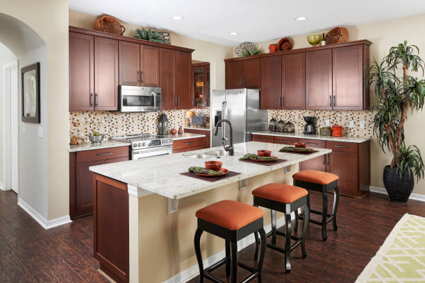 istock A Brown, Orange, and Tan Kitchen with a Tan and Black speckled Backsplash in a Model Home 1051972594