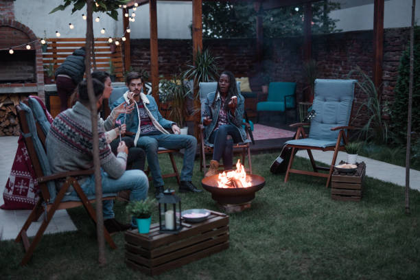 istock Group of Friends Gathered Around a Fire Pit 1051984478