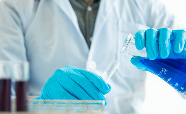 istock Close up. Medical or science medical in laboratory room research performs tests with liquid, Experimental Drug Treatment 1052005308