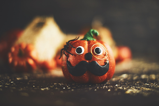 Pumpkin character with mustache and monocle