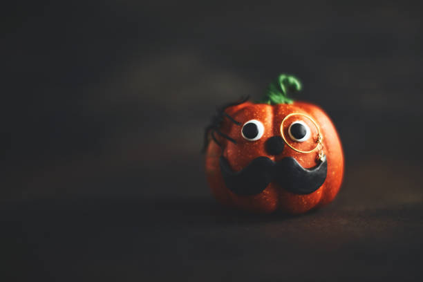 Pumpkin gentleman character with mustache and monocle