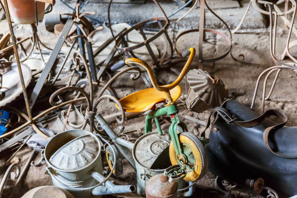 View of a vintage tricycle in a junkyard.