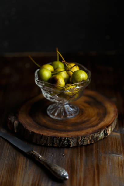 istock Wild pear in a glass bowl on a wooden dark background. Rustic concept 1052008882