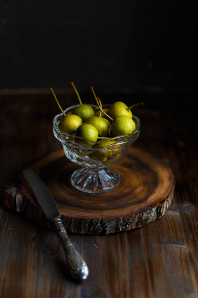 istock Wild pear in a glass bowl on a wooden dark background. Rustic concept Copy space 1052008898