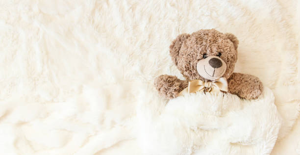 istock children's toy sleeps under the blanket. copy space. Selective focus. 1052038610