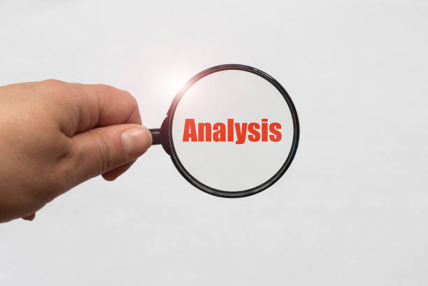 istock magnifying glass in hand and a Analysis word on the white background 1052047510