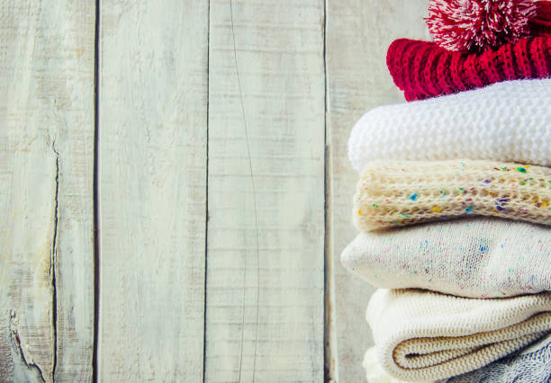 istock Warm Winter Clothes on a wooden background. Selective focus. 1052048260