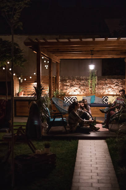 istock Group of friends talking and drinking beer in pergola 1052049580