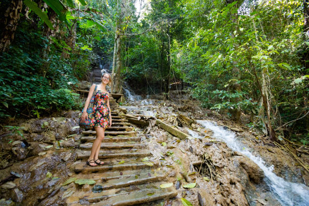 istock Girl on Kuang Si waterfall 1052051746