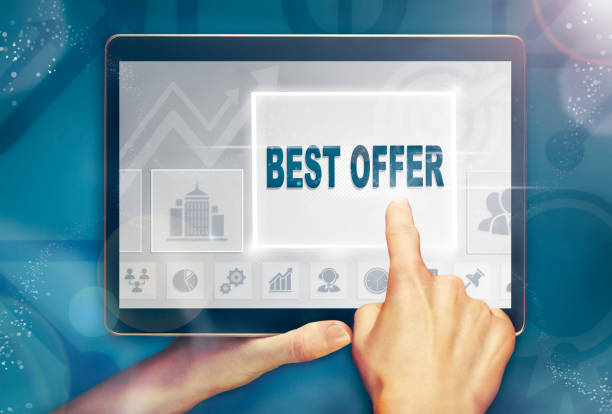 istock A hand holding a computer tablet and pressing a best offer concept. 1052059296