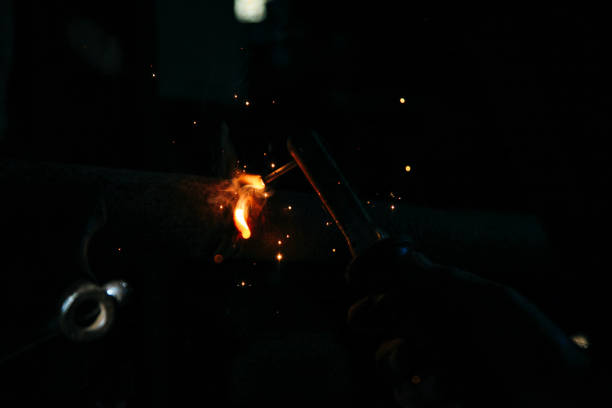 istock Welder welding metal in workshop with sparks 1052073670