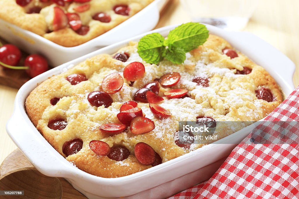 Cherry sponge cake Freshly baked cherry sponge cake in a porcelain casserole dish Baked Stock Photo