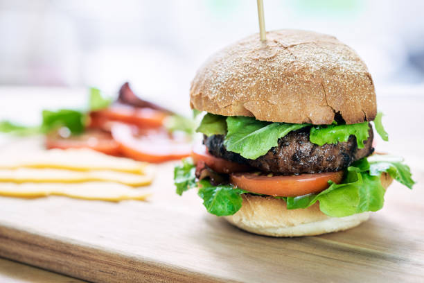 istock A beef burger in a crusty bun with lettuce and tomatoes 1052111484