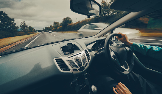 Un conductor mujer conducir un coche a lo largo de una carretera muy transitada photo