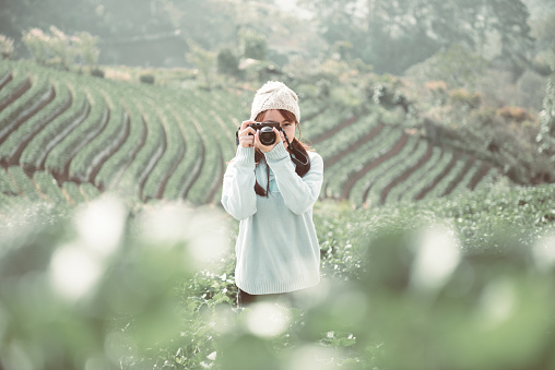 Tourist woman capturing the moment. Hipster photographer using camera.